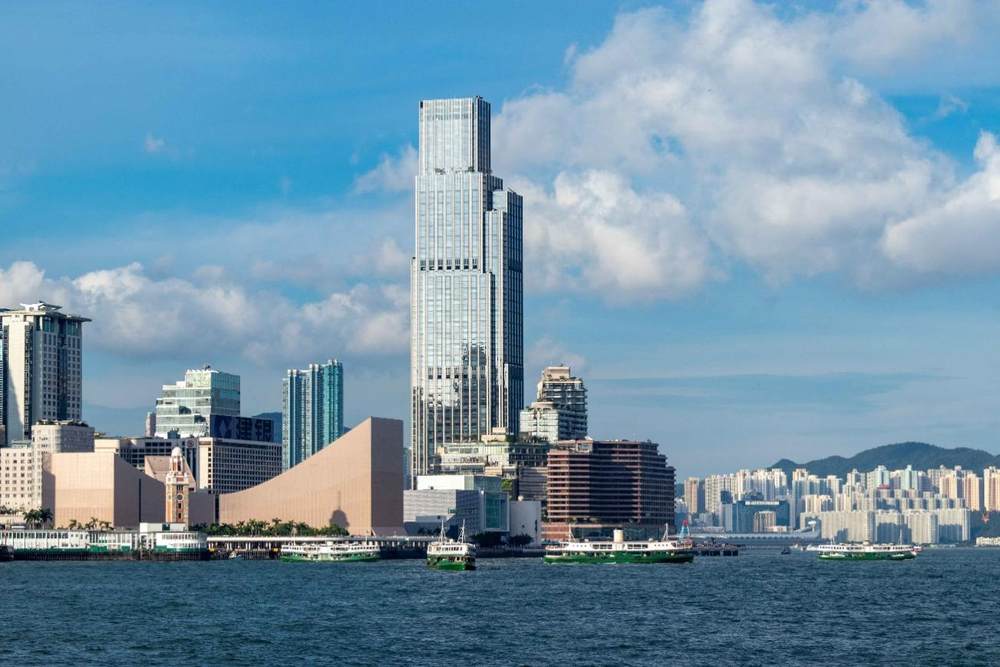A city skyline with boats on the waterDescription automatically generated